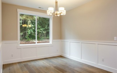 Dining Room has hardwood flooring and white wainscoting.