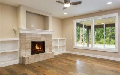 Propane fireplace is flanked by built-in cabinetry.